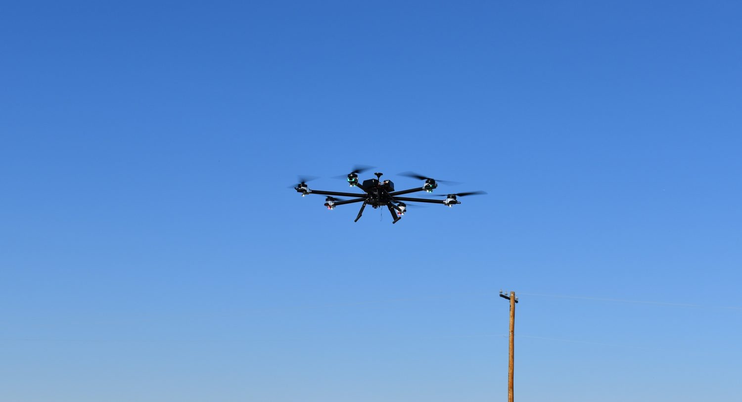 The hexacopter hovering against a clear sky during the 18-minute test